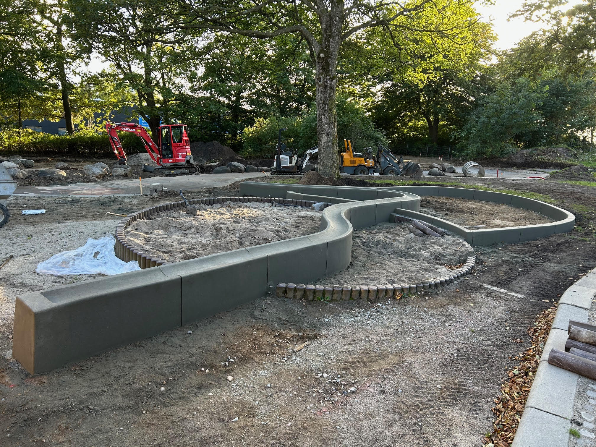 Concrete water channel running through a park, poured on site